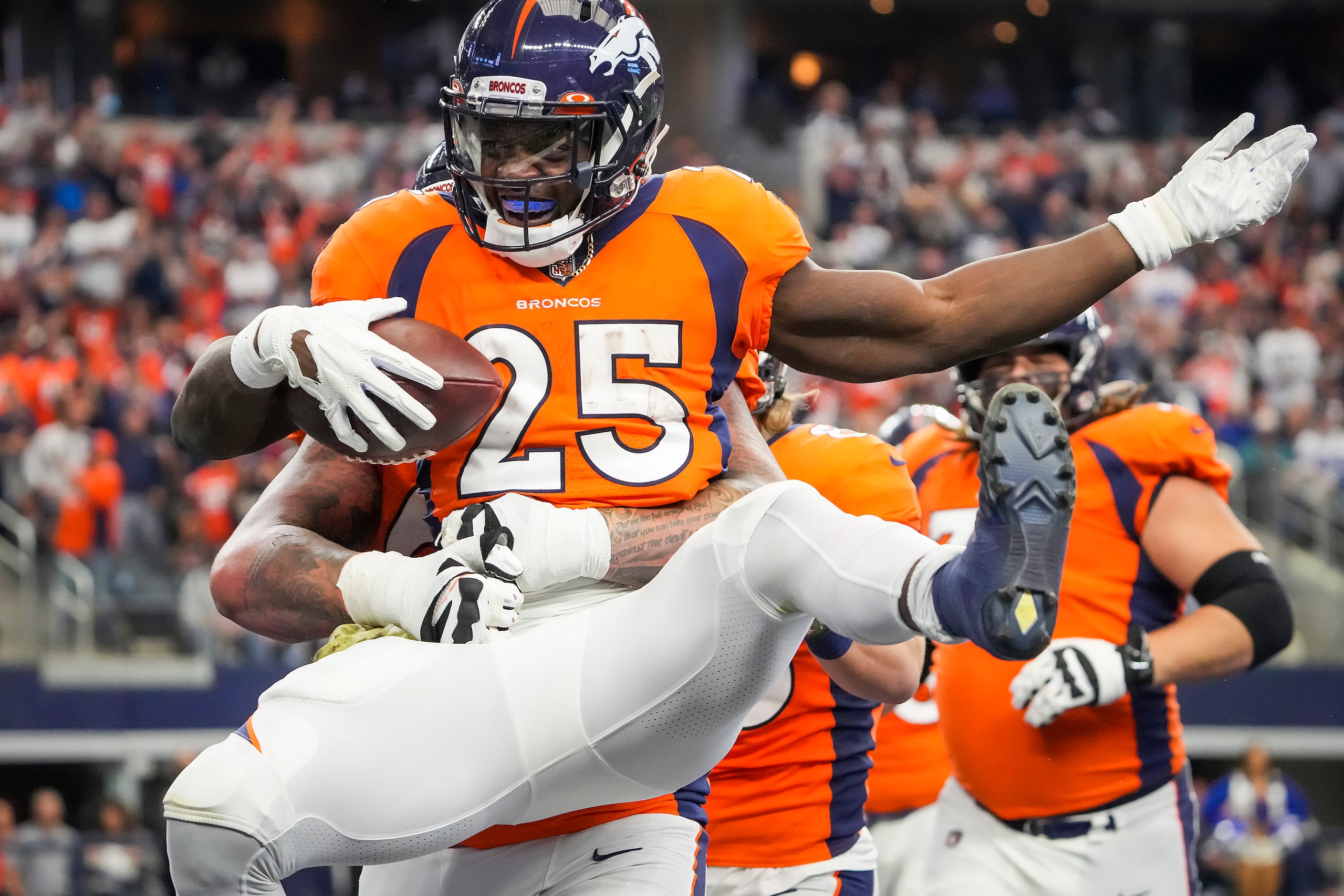 Denver Broncos running back Melvin Gordon (25) celebrates after scoring on a 3-yard...