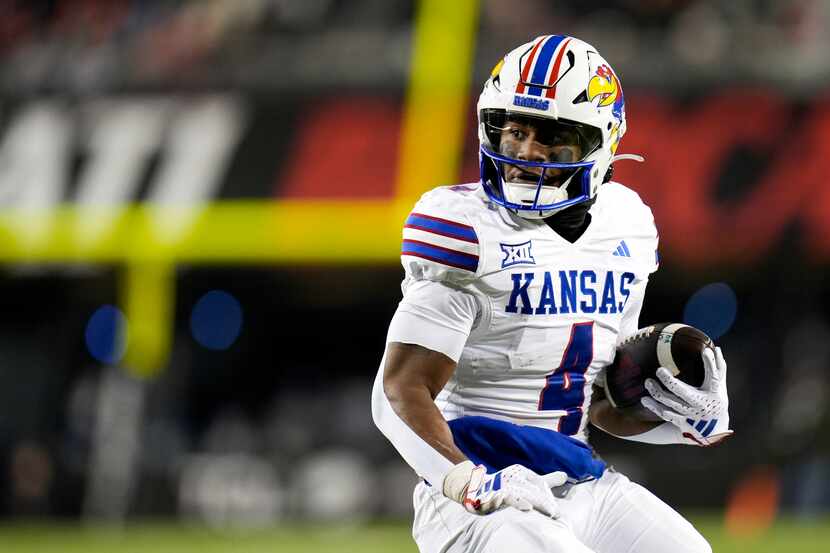 Kansas running back Devin Neal scores a touchdown against Kansas during an NCAA college...