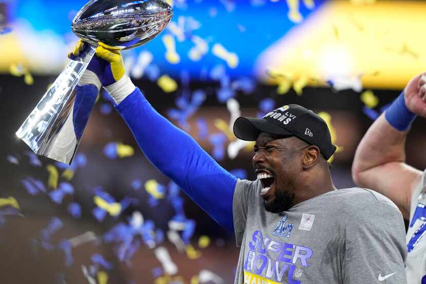 Los Angeles Rams outside linebacker Von Miller holds up the Lombardi Trophy after the Rams...