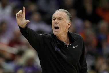 TCU head coach Jamie Dixon motions to his players during the first half of an NCAA college...