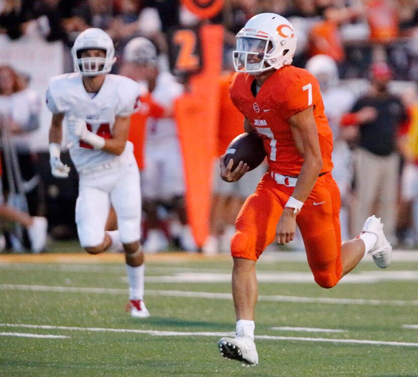 Celina High School quarterback Noah Ross (7) runs for a touchdown during the first half as...