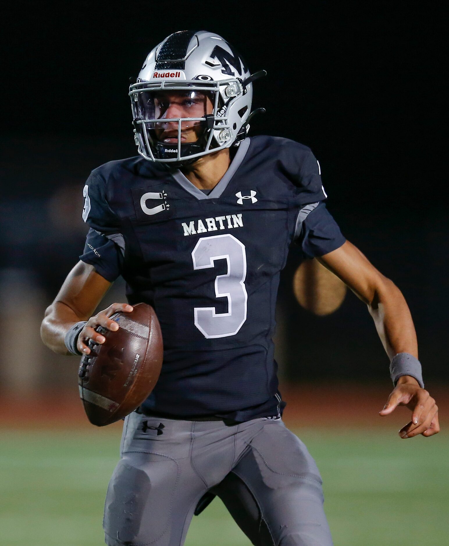 Arlington Martin senior quarterback Cydd Ford (3) looks for an open receiver during the...