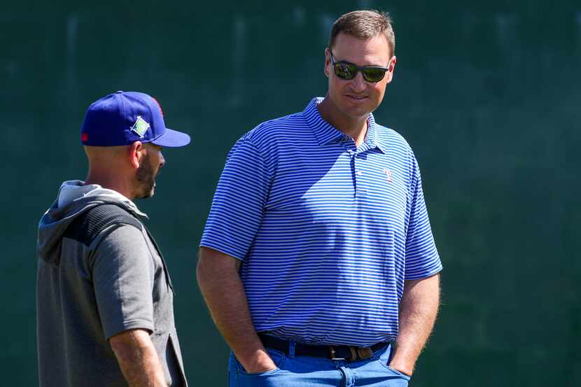 Texas Rangers general manager Chris Young (right) talks with manager Chris Woodward during a...