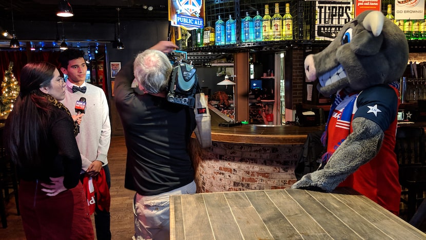 Ricardo Pepi does a TV interview while FC Dallas mascot Tex Hooper looks on.