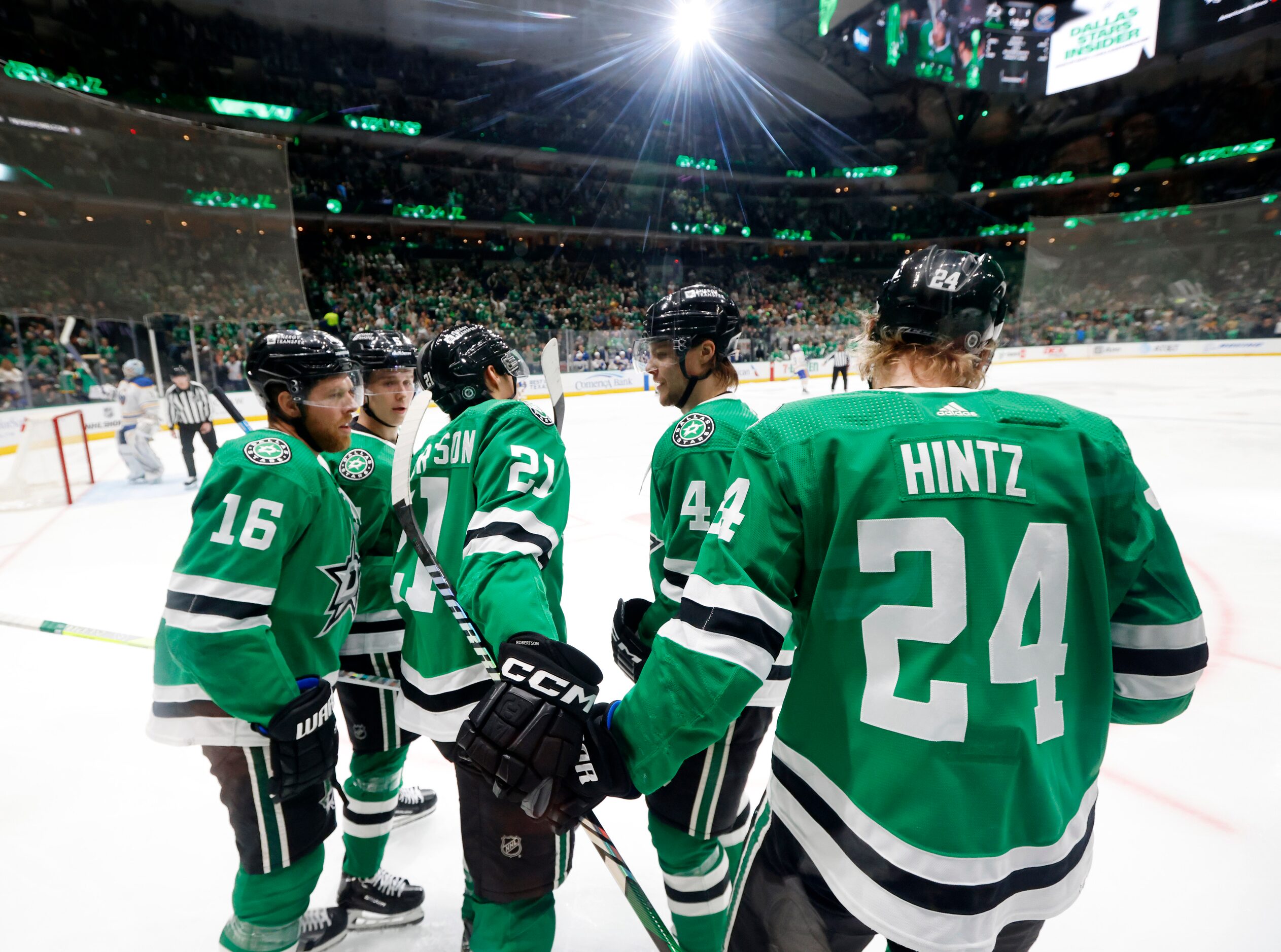 Dallas Stars left wing Jason Robertson (21) is congratulated by teammates Joe Pavelski (16),...