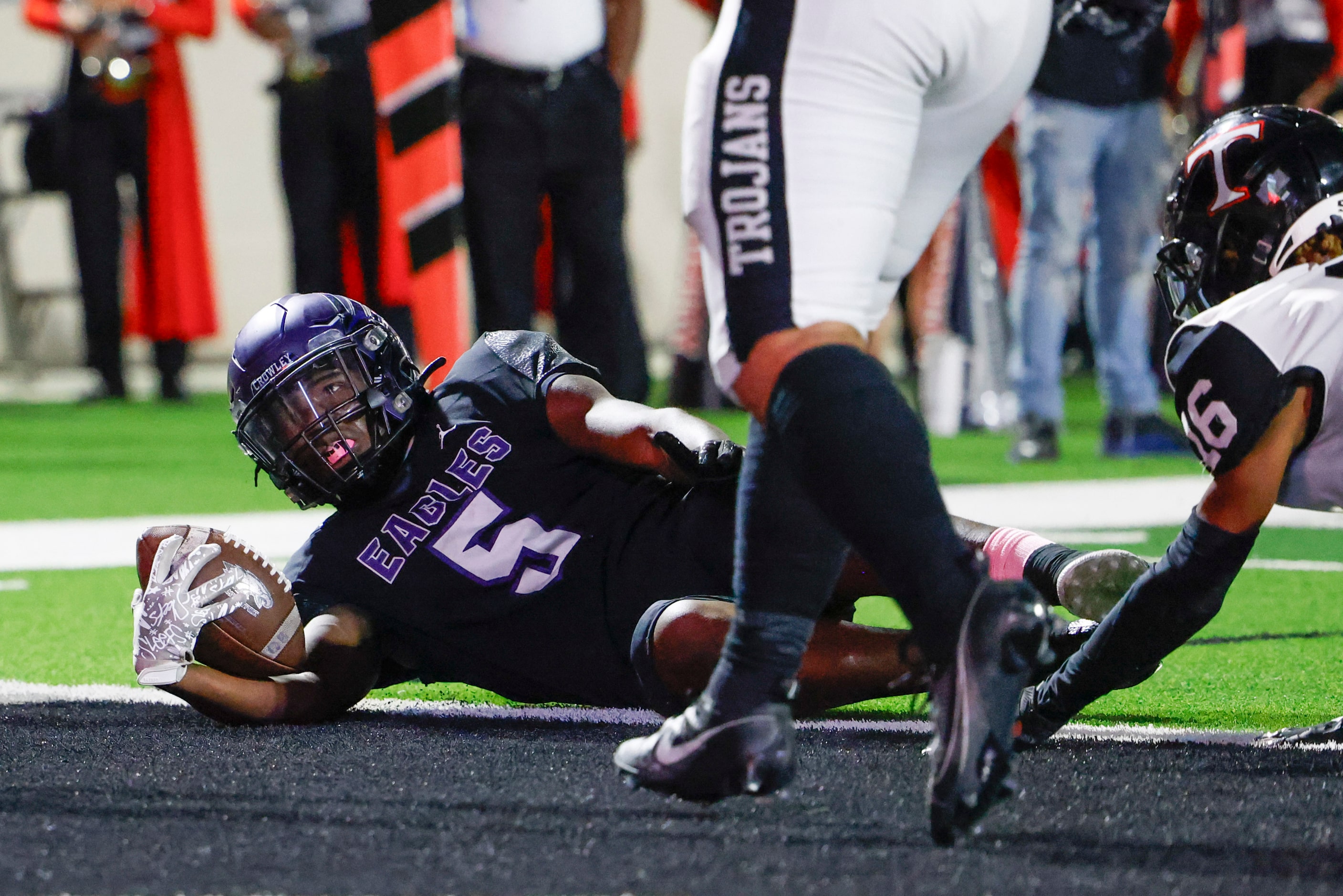 Crowley High’s Caleb Pope (right) scores a touchdown against Trinity High during the first...