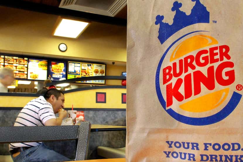 FILE - In this Aug. 24, 2010 file photo, patrons enjoy a meal at a Burger King in...