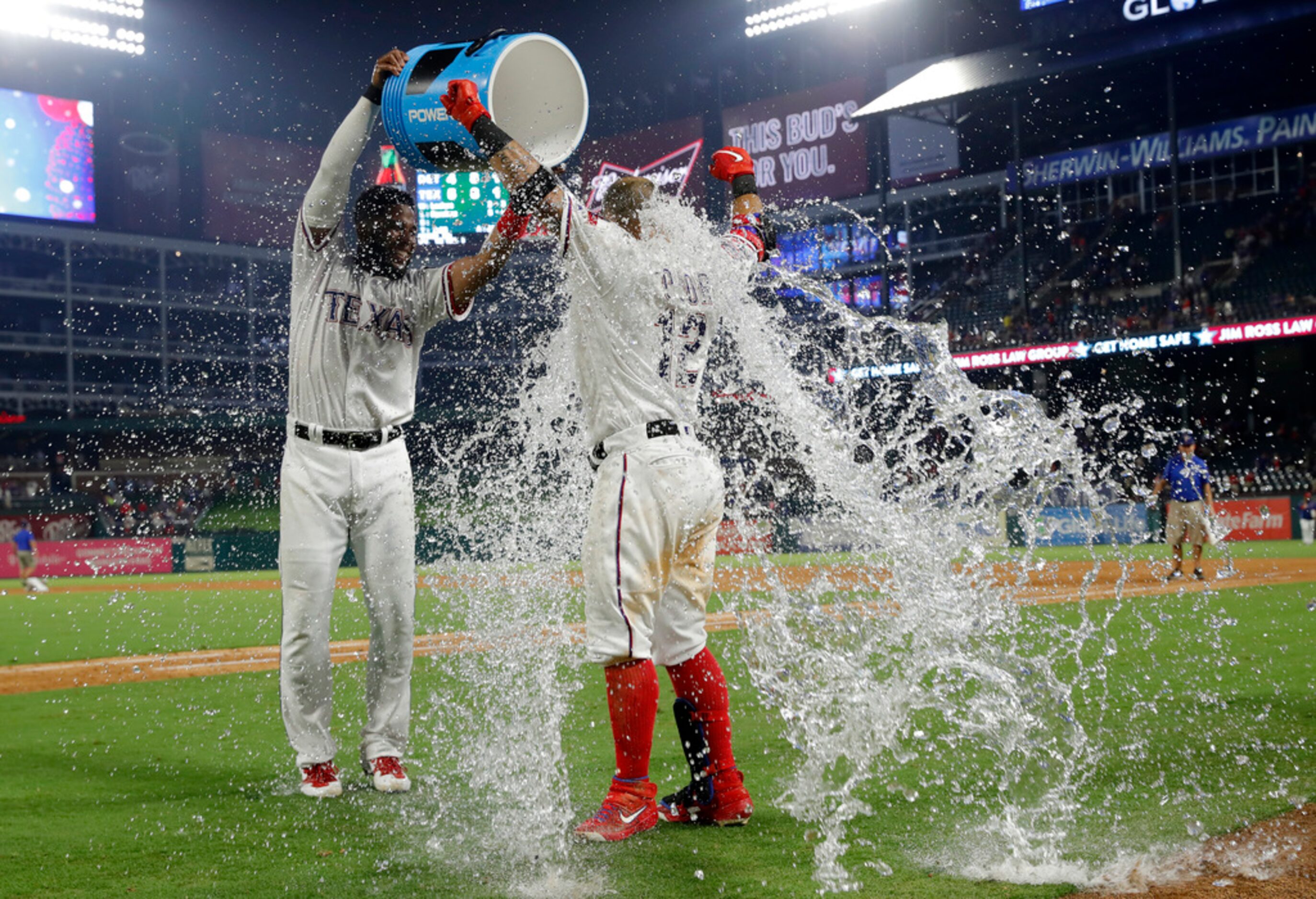 Texas Rangers' Elvis Andrus, left, douses Rougned Odor after the Rangers' 5-4 win against...