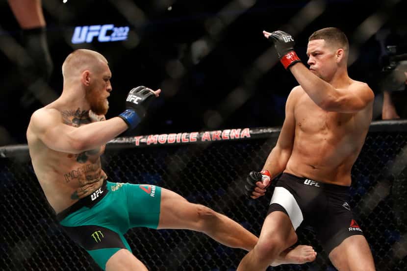 LAS VEGAS, NV - AUGUST 20:  Conor McGregor (L) kicks Nate Diaz during their welterweight...