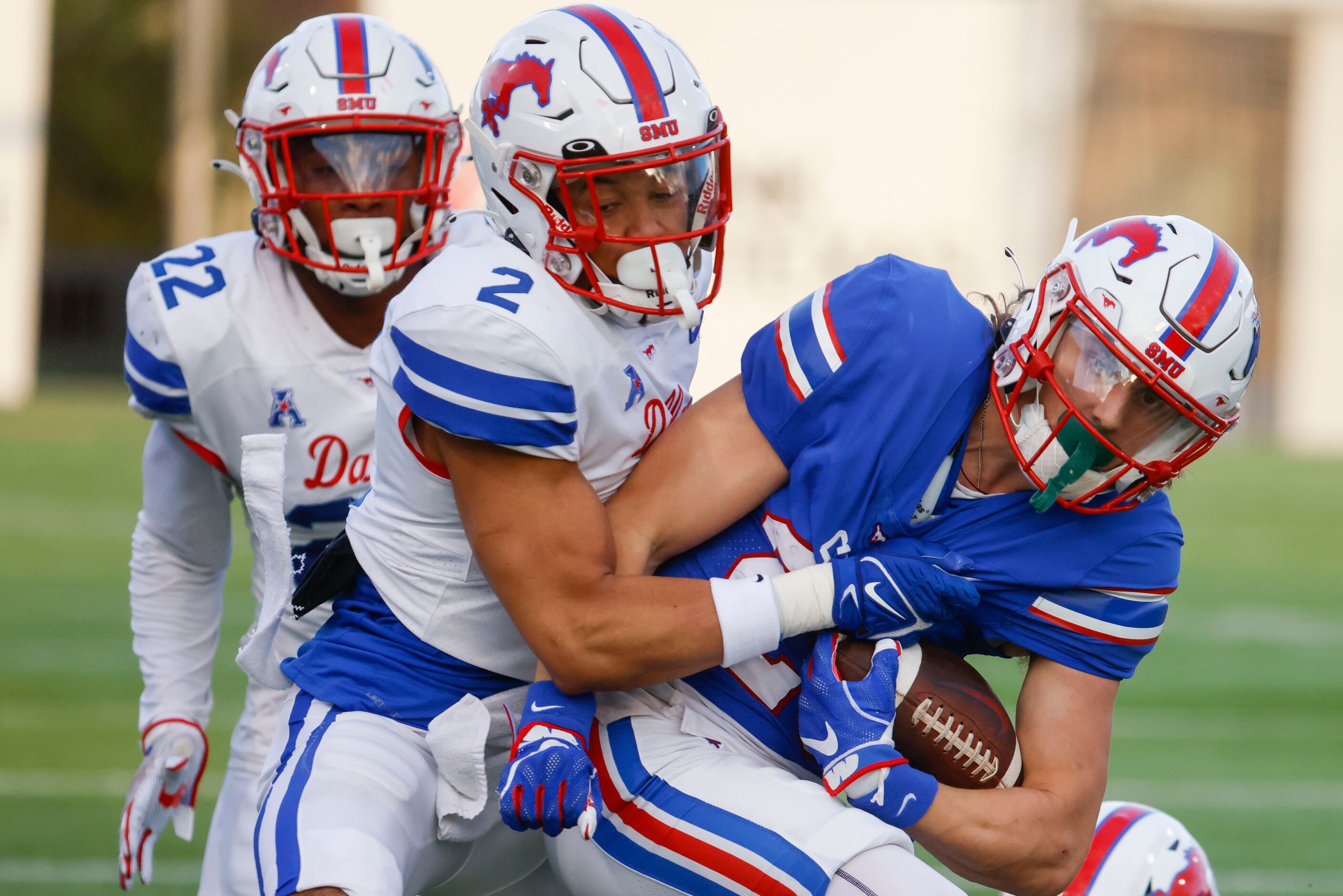 Southern Methodist safety Isaiah Nwokobia (center) tackles Southern Methodist wide receiver...