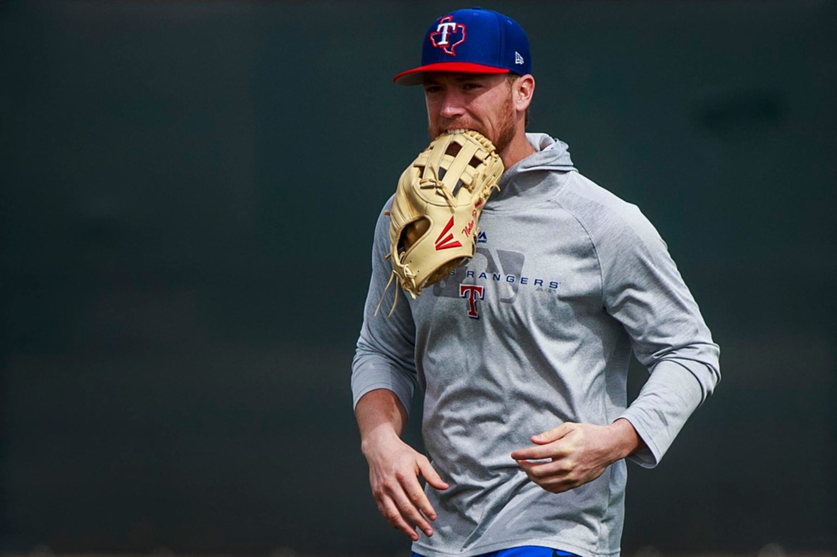 Texas Rangers infielder Nolan Fontana takes the field for batting practice during a spring...