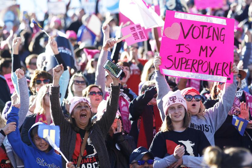 Attendees cheer a speaker during the Women's March "Power to the Polls" voter registration...