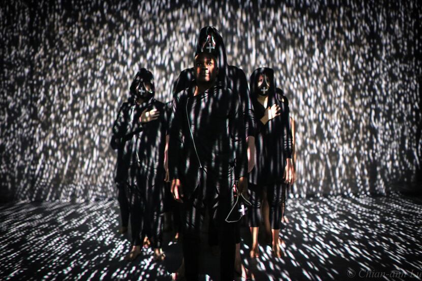 The performers in Charles O. Anderson's (Re)current Unrest are often drenched in projected...