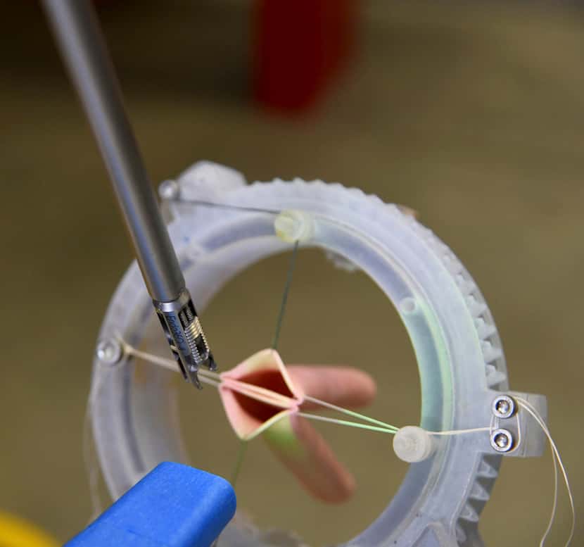 A detail of a robot's suturing arm working on simulated blood vessels is shown March 17 in...