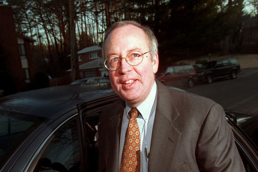 In this file photo, Kenneth Starr pauses before getting into a car at his McLean, Va., home....