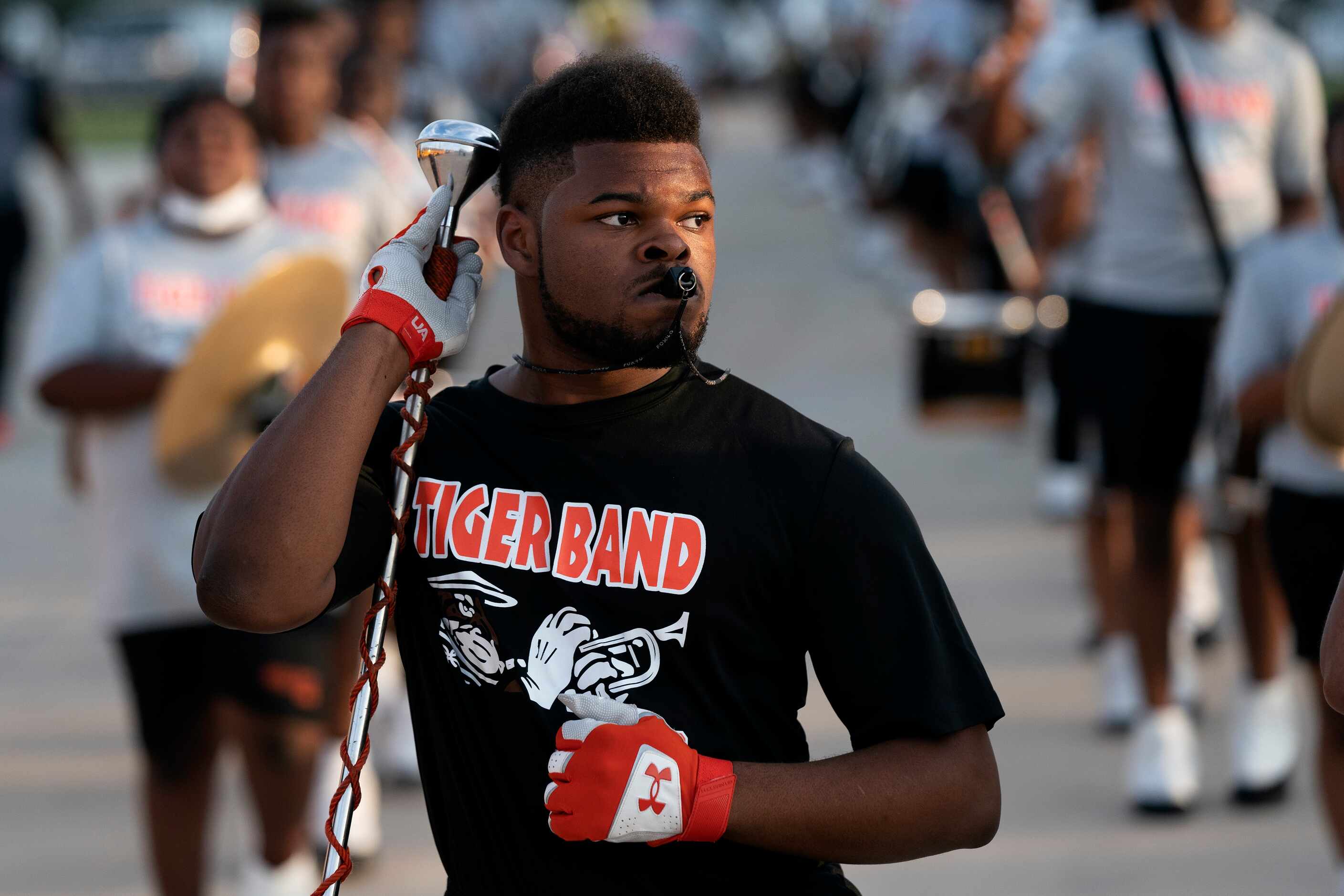 Lancaster head drum major Kamori Bougere leads the band into the stadium before a high...