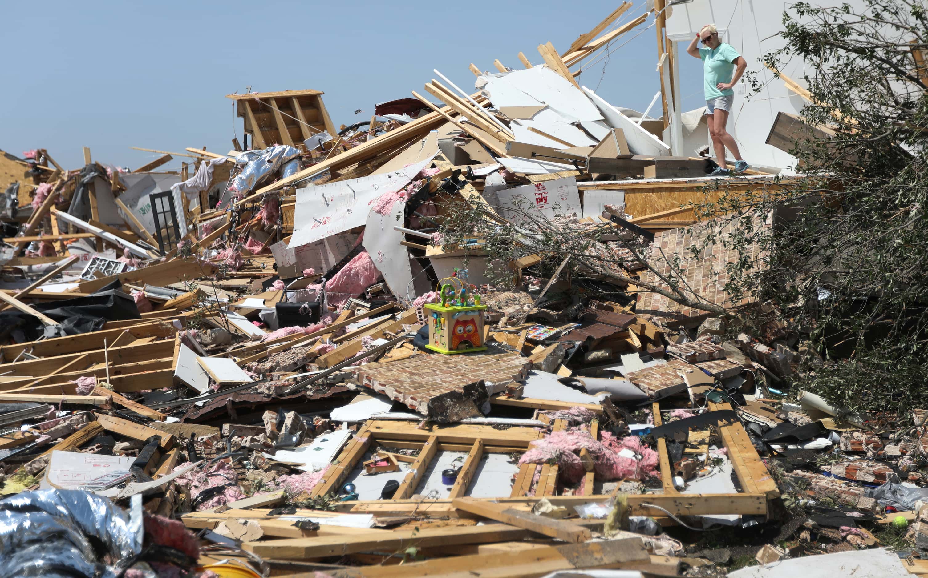 Celina teacher Susan Swift surveys the damage in Celina, Texas, Sunday May 26, 2024. 