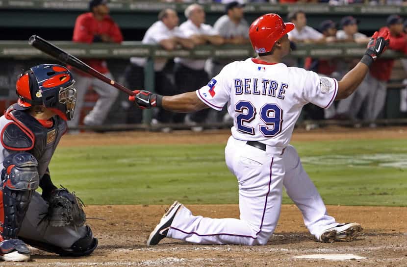 Texas 3B Adrian Beltre drops to a knee as he hits a homer in  the sixth inning during Game 5...