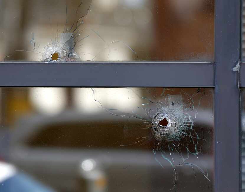 Two bullet holes in the windows of El Centro College are seen at the scene where the five...