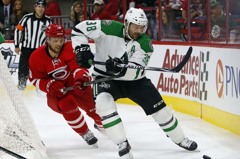Dallas Stars' Vernon Fiddler (38) works the puck behind the net in front of Carolina...