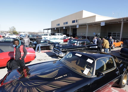 People preview available cars during an auction at Manheim in Dallas, Texas, December 18, 2024.