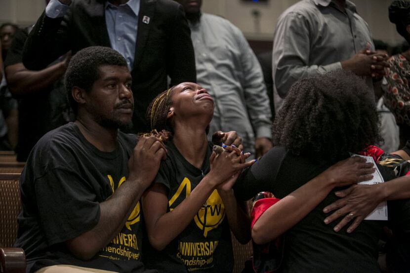 People pray during a service at Friendship-West Baptist Church in Dallas, July 10, 2016. The...