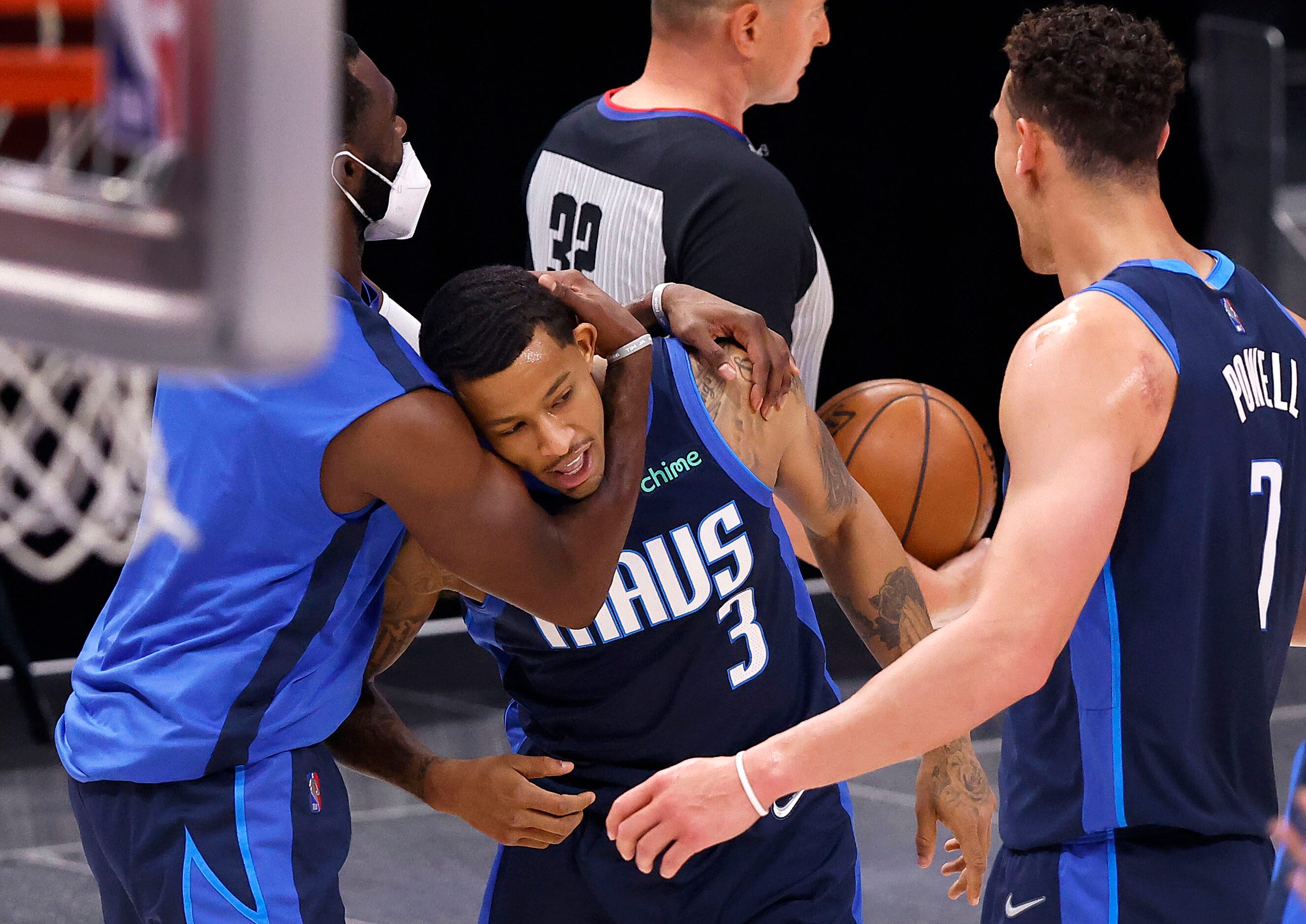 Dallas Mavericks guard Trey Burke (3) is congratulated by teammates after hitting a last...