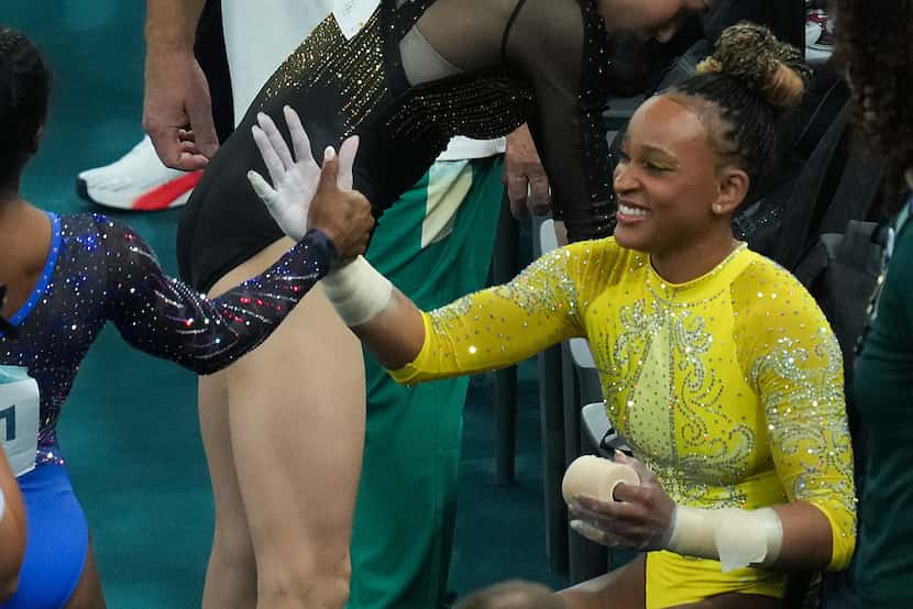 Rebeca Andrade of Brazil congratulates Simone Biles of the United States after she competed...