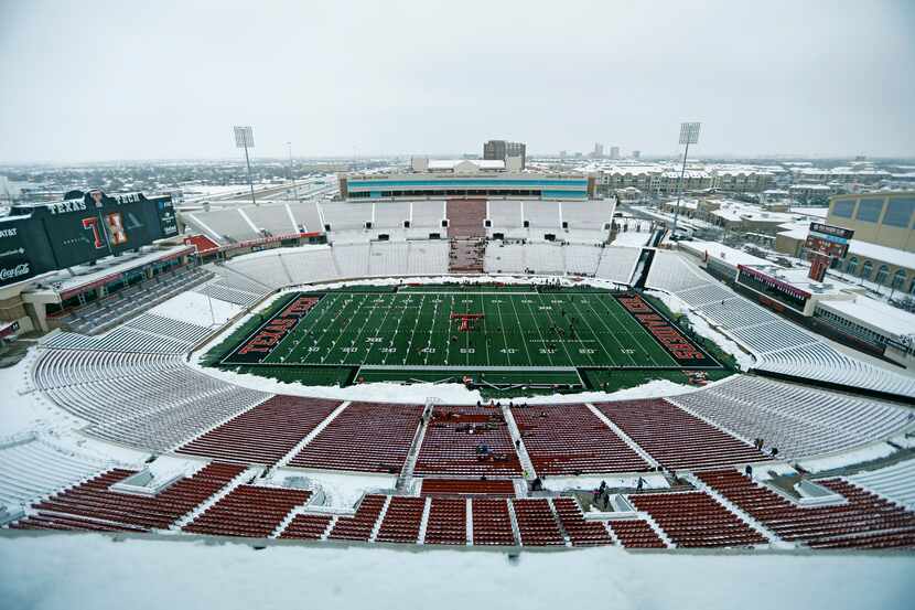 Snow covered the seats at Jones AT&T Stadium in Lubbock before the regional final game...