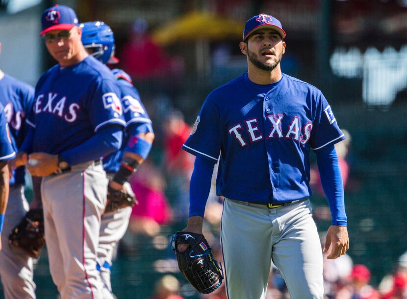 FILE - Texas Rangers starting pitcher Martin Perez (33) walks back to the dugout after being...