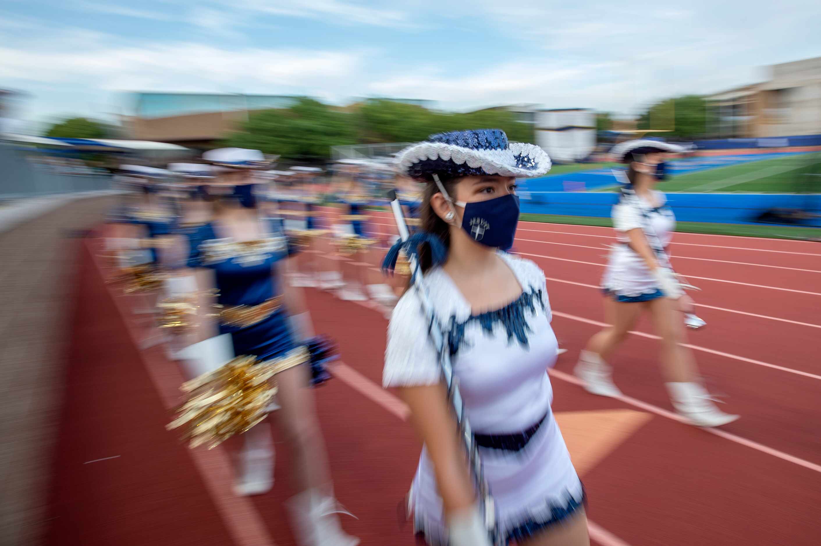Junior Jesuit Rangerette Melissa Torres takes the field before a high school football game...