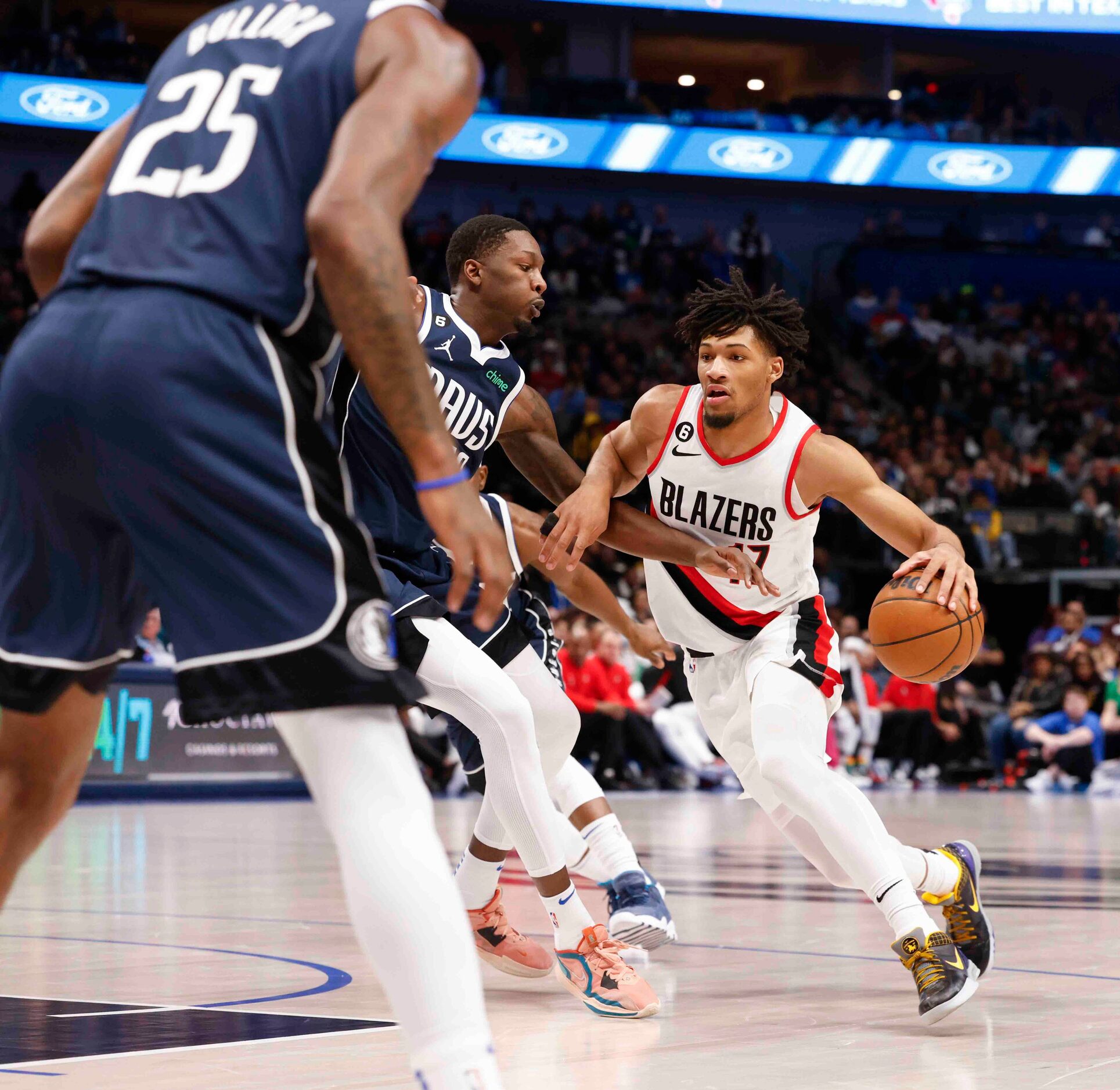 Portland Trail Blazers guard Shaedon Sharpe (17), right, dribbles the ball past Dallas...