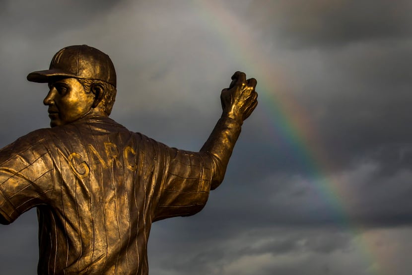 A rainbow forms behind statues lining the entrance to Isidoro Garcia Stadium before a Puerto...
