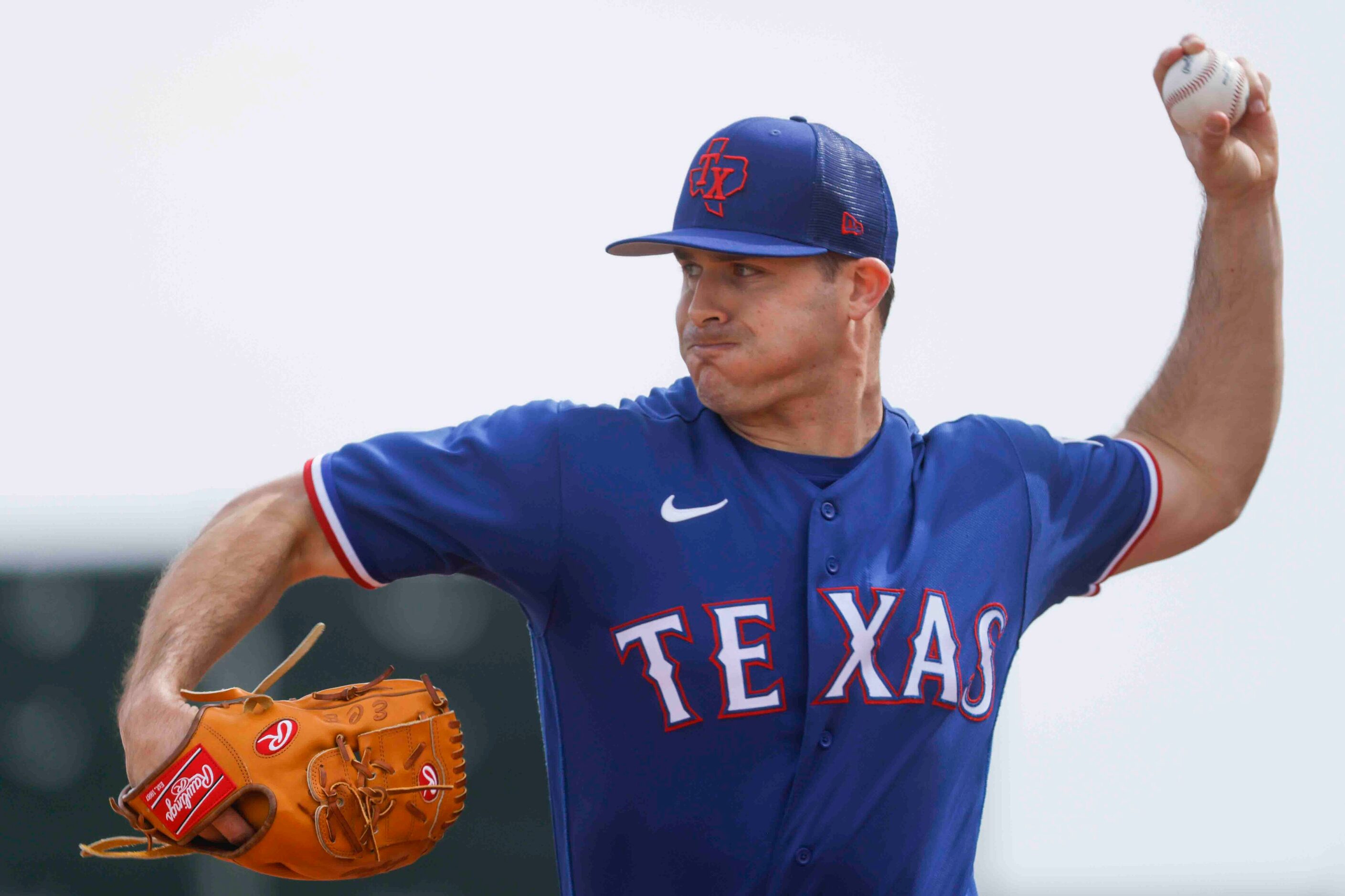 Texas Rangers pitcher John King throws a pitch during a spring training workout at the...