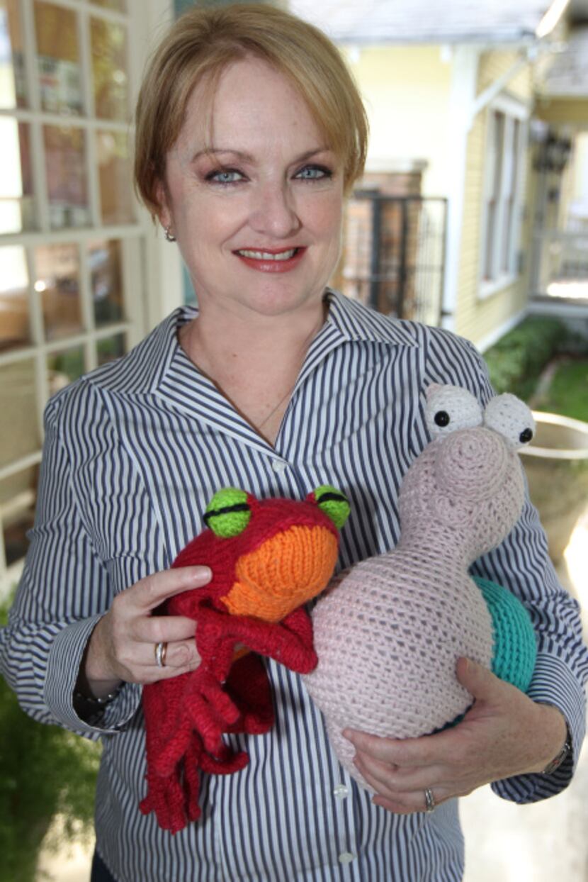 Sharon Miller of University Park holds two of her creations at the Shabby Sheep, which is...