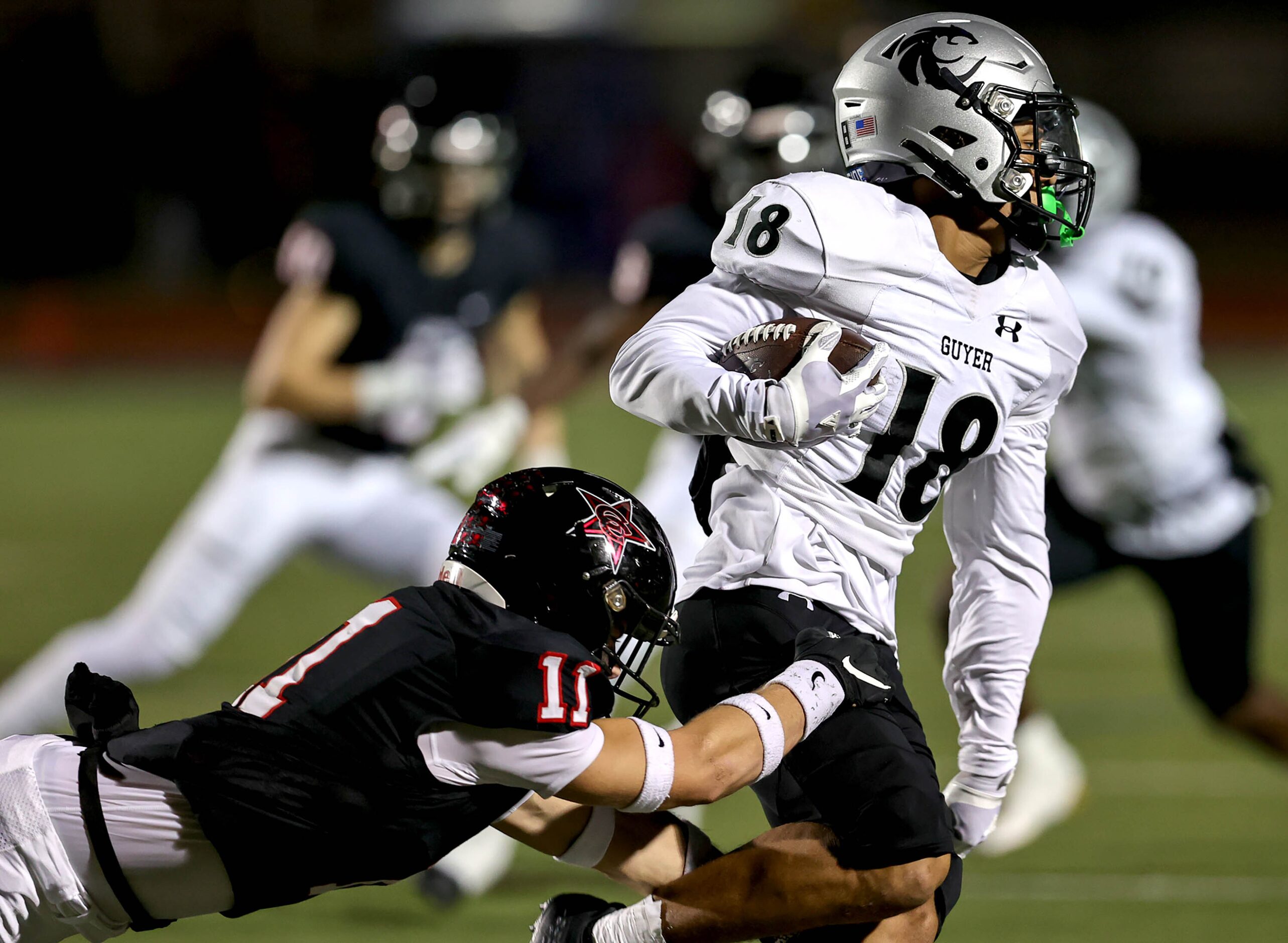 Denton Guyer wide receiver Eli Bowen (18) makes the catch and is immediately stopped by...