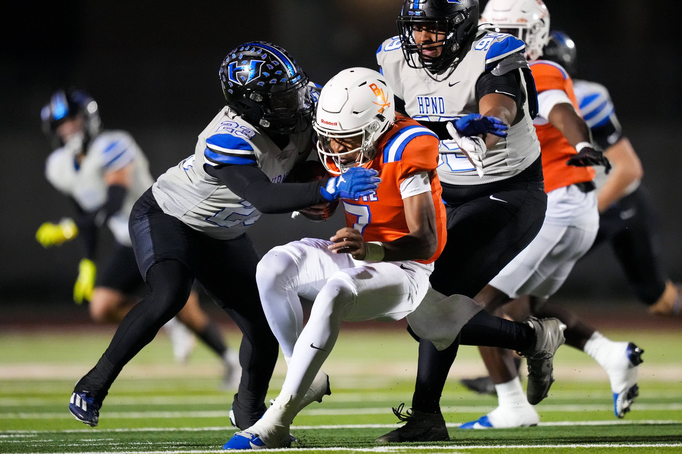 Arlington Bowie quarterback Larry Nichols (7) is dropped for a loss by Hebron linebacker...