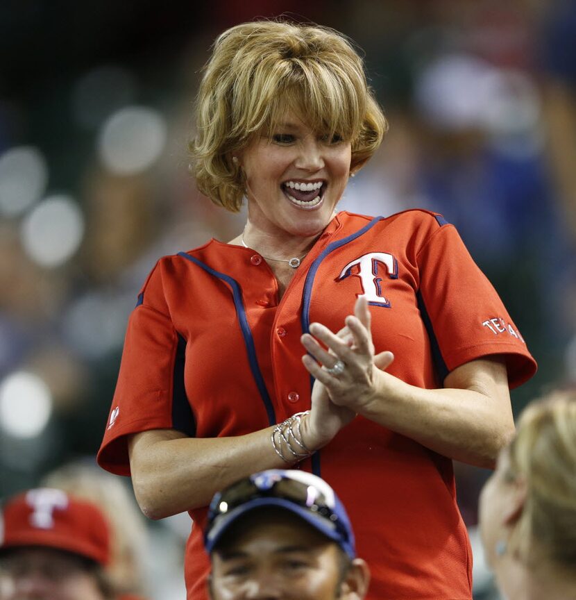 A Texas Rangers fan dances in between inning in a game against the Detroit Tigers at Globe...