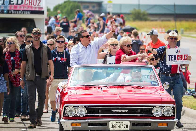 Texas Sen. Ted Cruz waved at the crowd during a Fourth of July parade in Rockwall on...