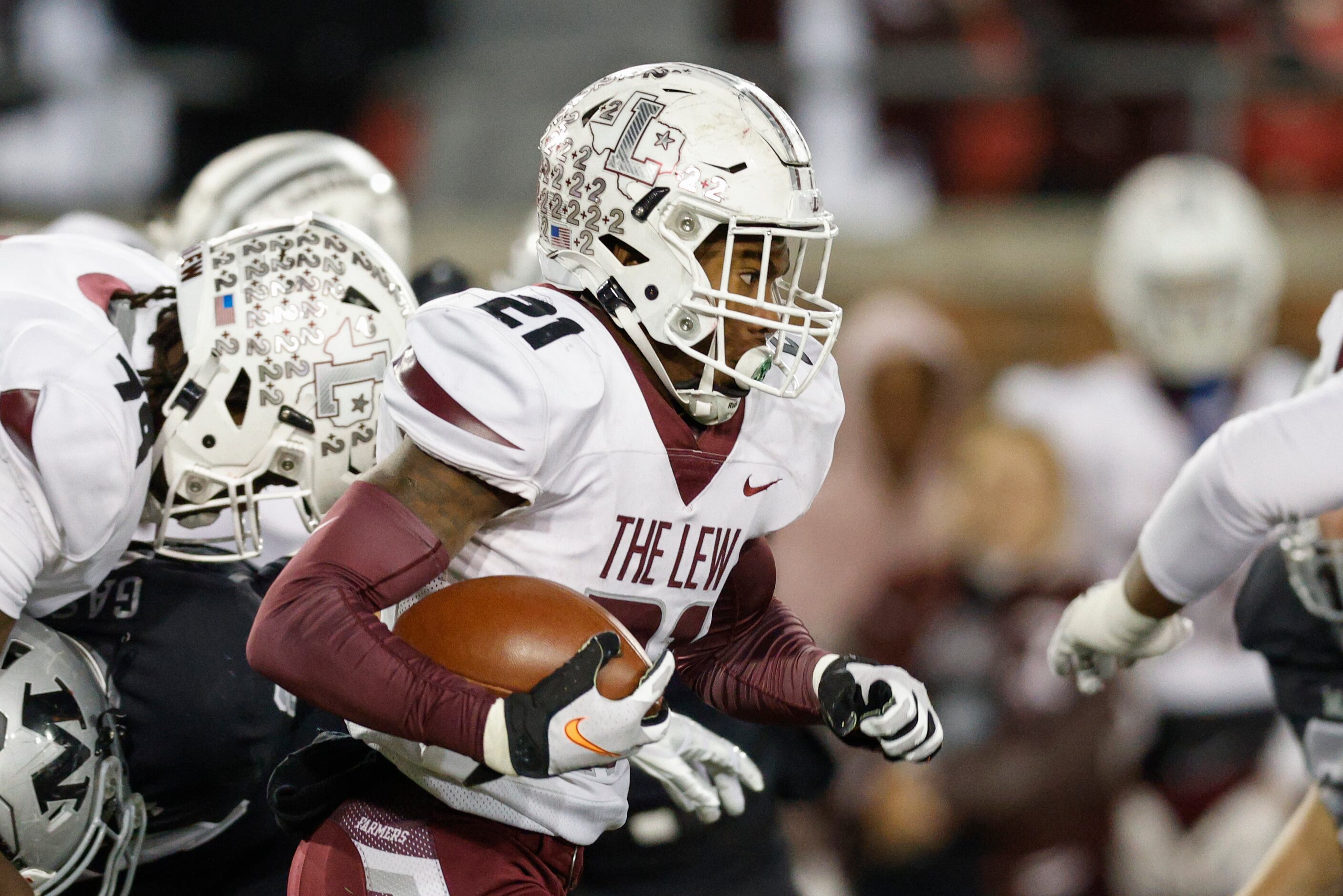 Lewisville running back Viron Ellison (21) runs through the line of scrummage during the...