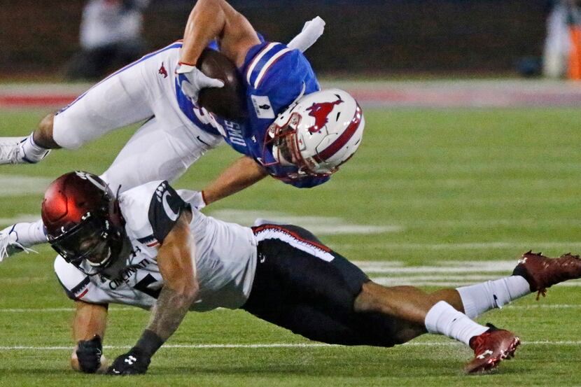 Southern Methodist Mustangs wide receiver Tyler Page (4) is upended by Cincinnati Bearcats...