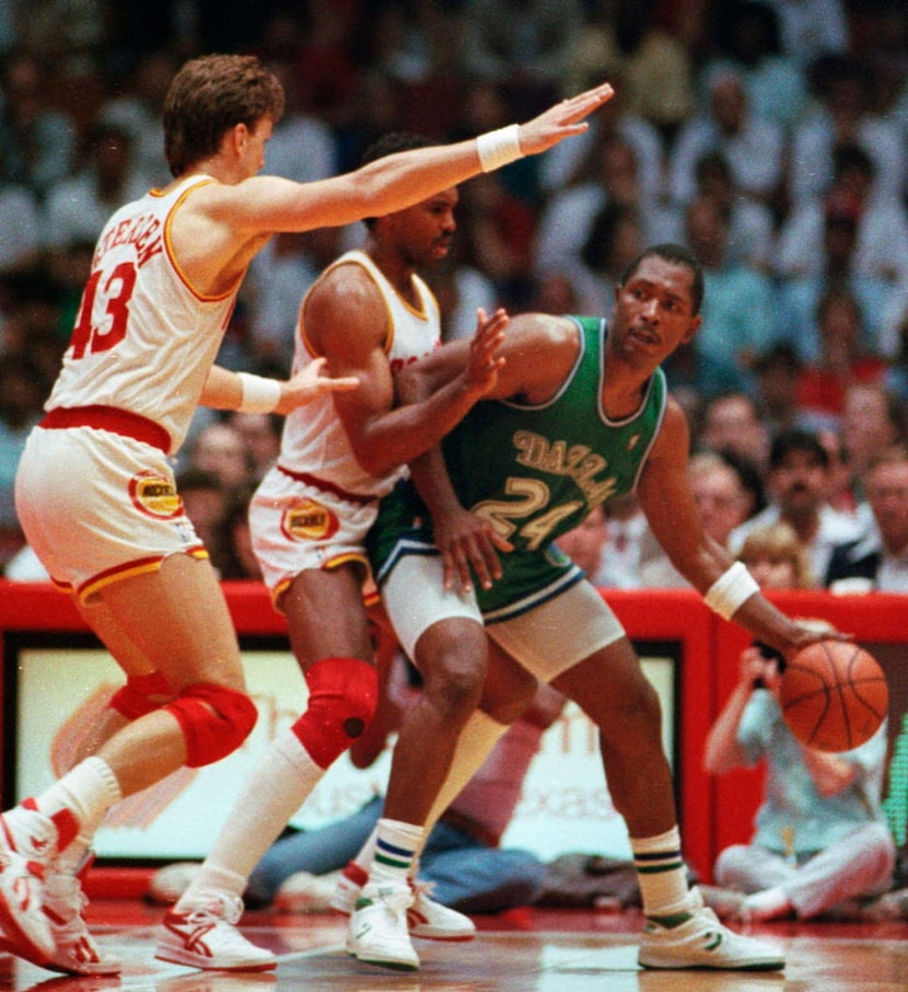 Dallas Mavericks forward Mark Aguirre (24) is pressured by the Houston Rockets defense,...