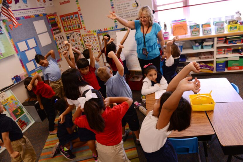 Dual language teacher Gina Fernandez talks to her students in Spanish during a lesson at...