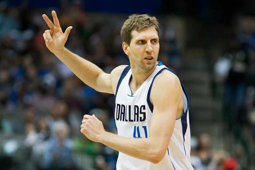 Dallas Mavericks forward Dirk Nowitzki celebrates after hitting a 3-pointer during the first...