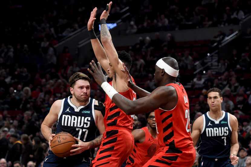 Dallas Mavericks guard Luka Doncic (77) drives to the basket against Portland Trail Blazers...