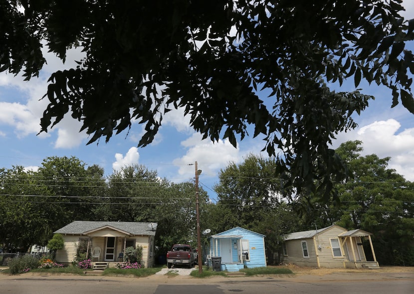 Three houses on Nomas Street in West Dallas, all owned by HMK.