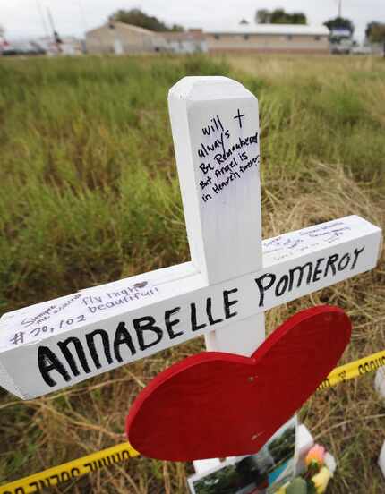 A wooden cross near First Baptist Church in Sutherland Springs honors 14-year-old Annabelle...