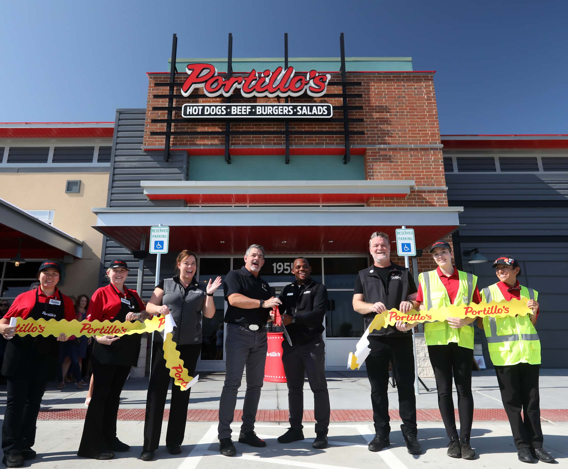 Dignitaries cut a ribbon at the grand opening ceremony at Portillo's in Allen on Sept. 7, 2023.