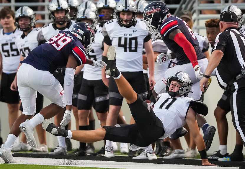 Denton Guyer quarterback Jackson Arnold  (11) is thrown out of bound by Denton Ryan...