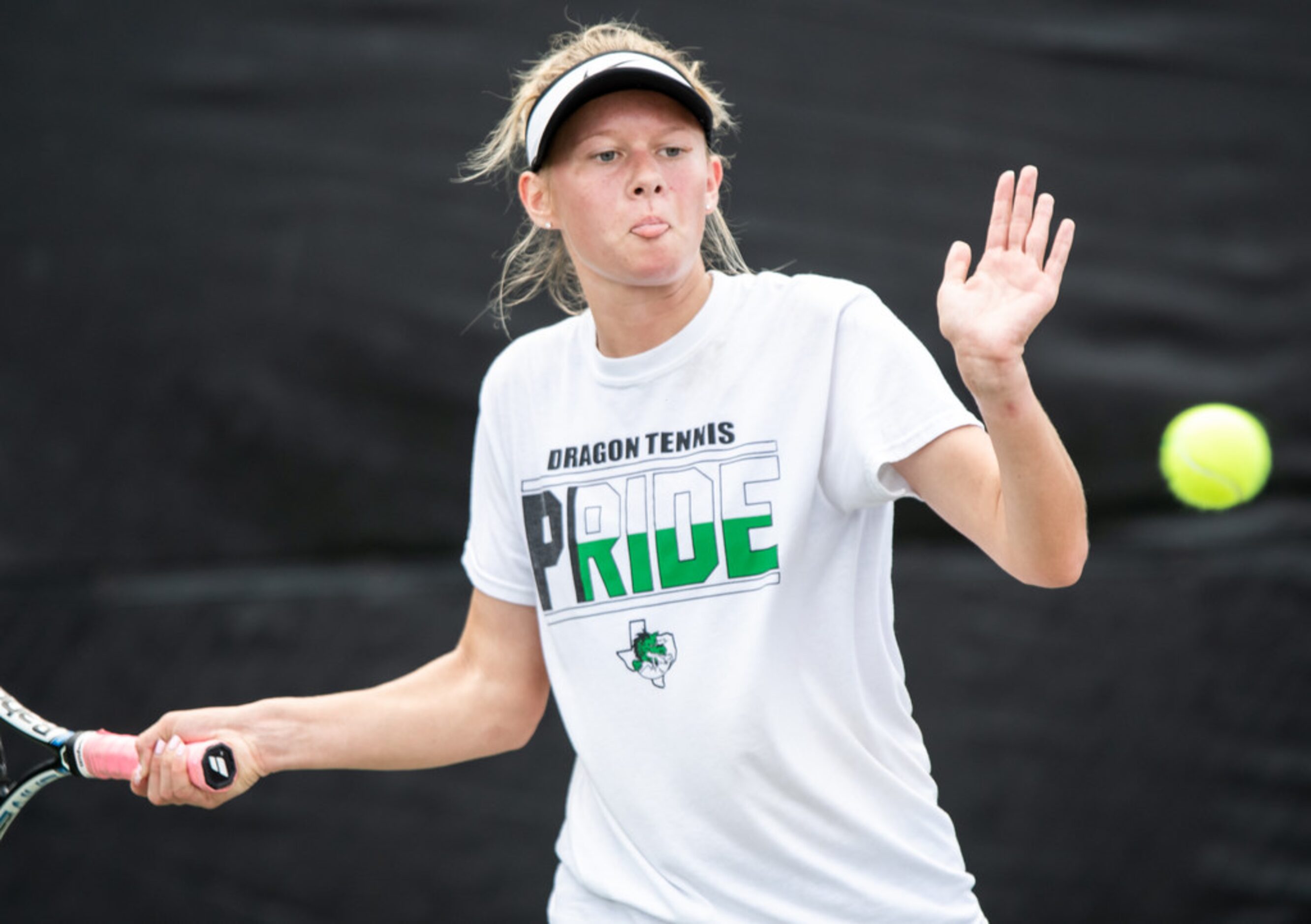 Southlake Carroll's Kelly Kunz returns the ball in a doubles match with teammate Drake Ferri...